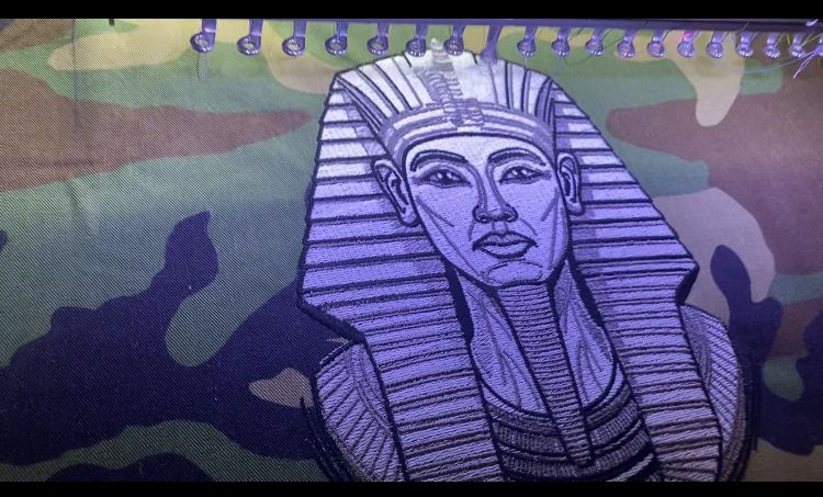 A drawing of a pharaoh on a camouflage background