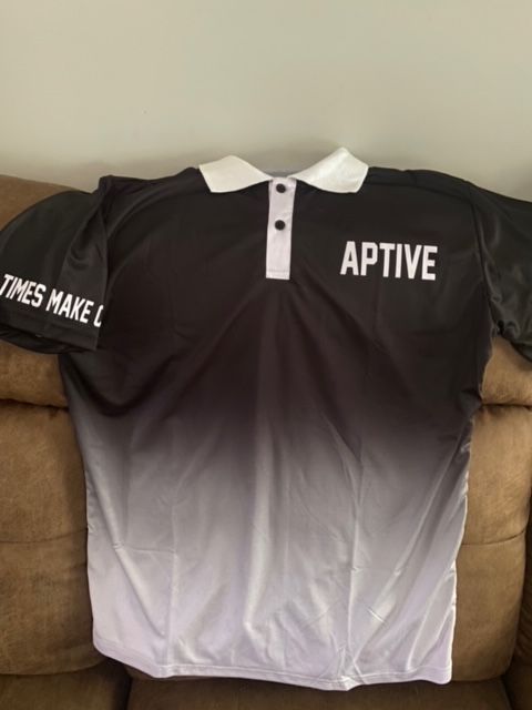 A black and white shirt that says aptive on the back
