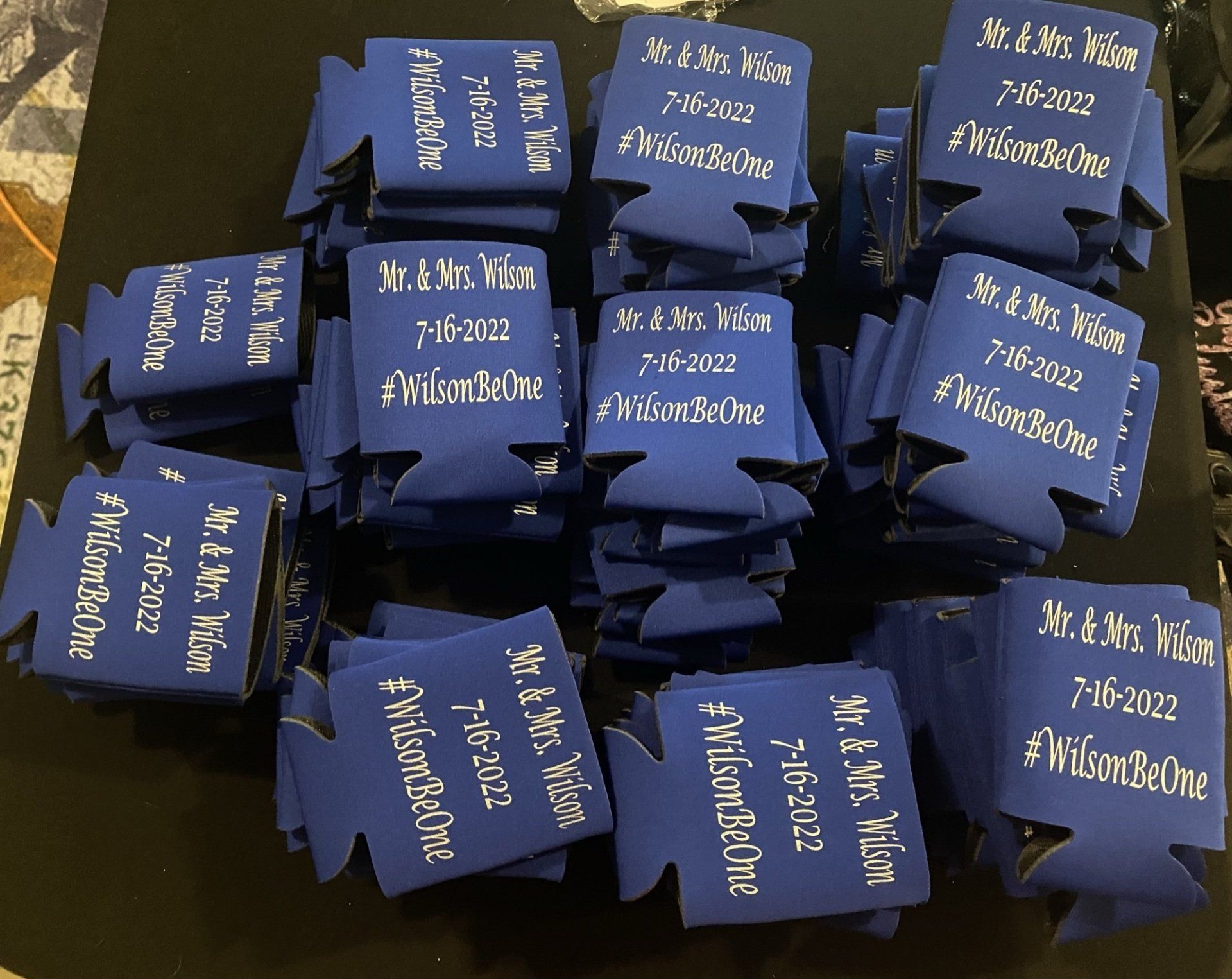 A bunch of blue can holders are stacked on top of each other