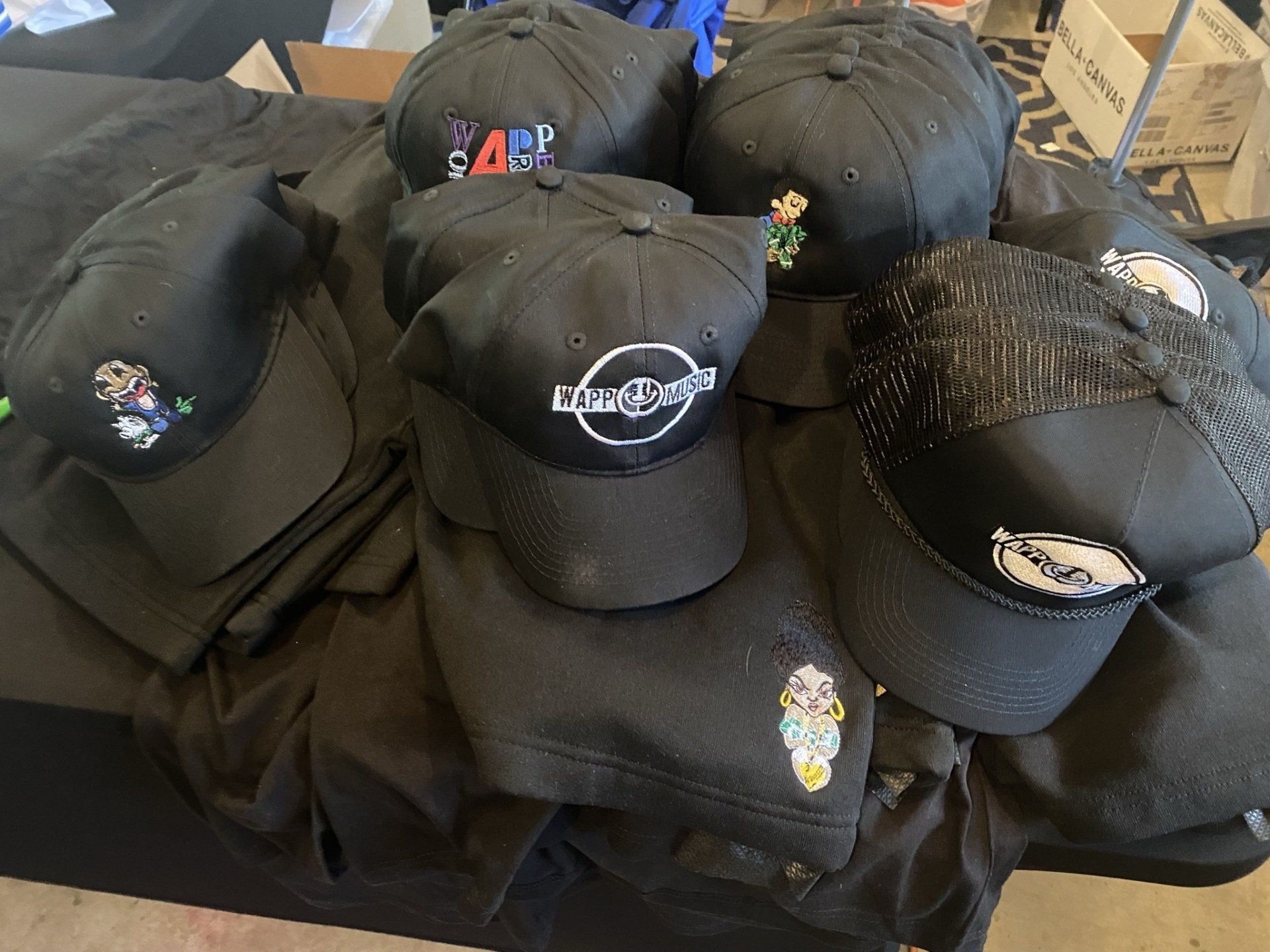 A bunch of black hats are stacked on top of each other
