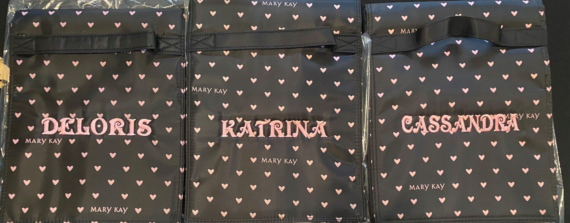 Three bags with the names deloris katrina and cassandra embroidered on them