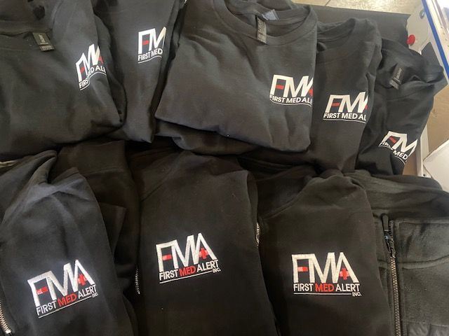 A bunch of black shirts with the word fma on them