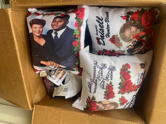 A box filled with pillows with a picture of a man and woman on them