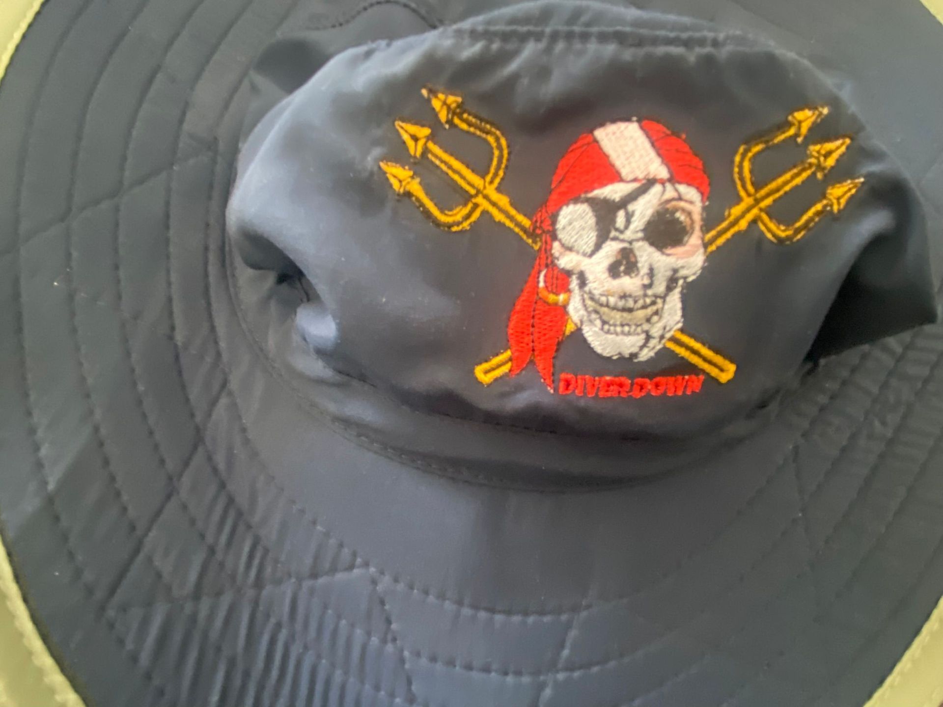 A black hat with a pirate embroidered on it