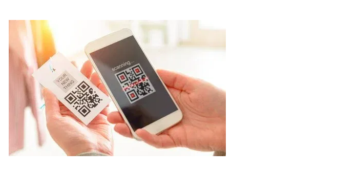 Person holding a smartphone displaying a QR code, alongside a tag with a similar QR code.