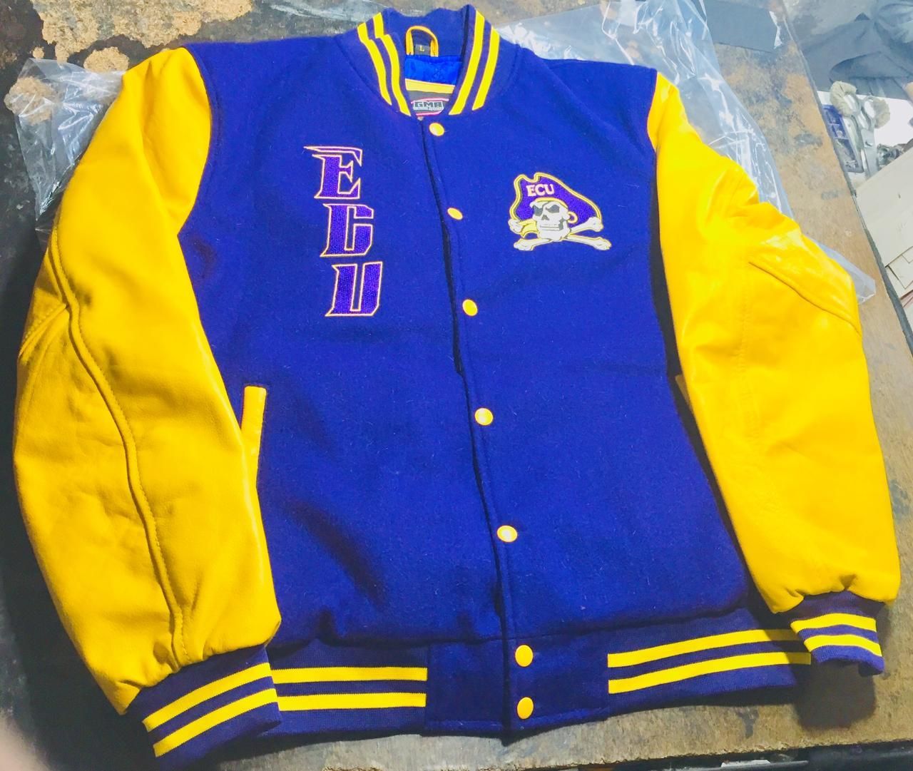 A blue and yellow varsity jacket with the letter e on the front