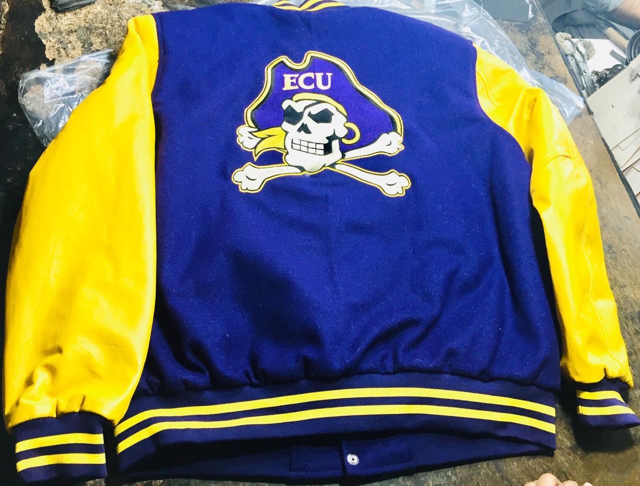 A blue and yellow jacket with ecu on the back