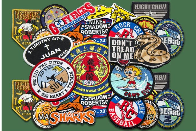 A bunch of patches on a green background one of which says flight crew