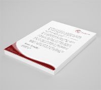 A piece of paper with a red border is sitting on a table.