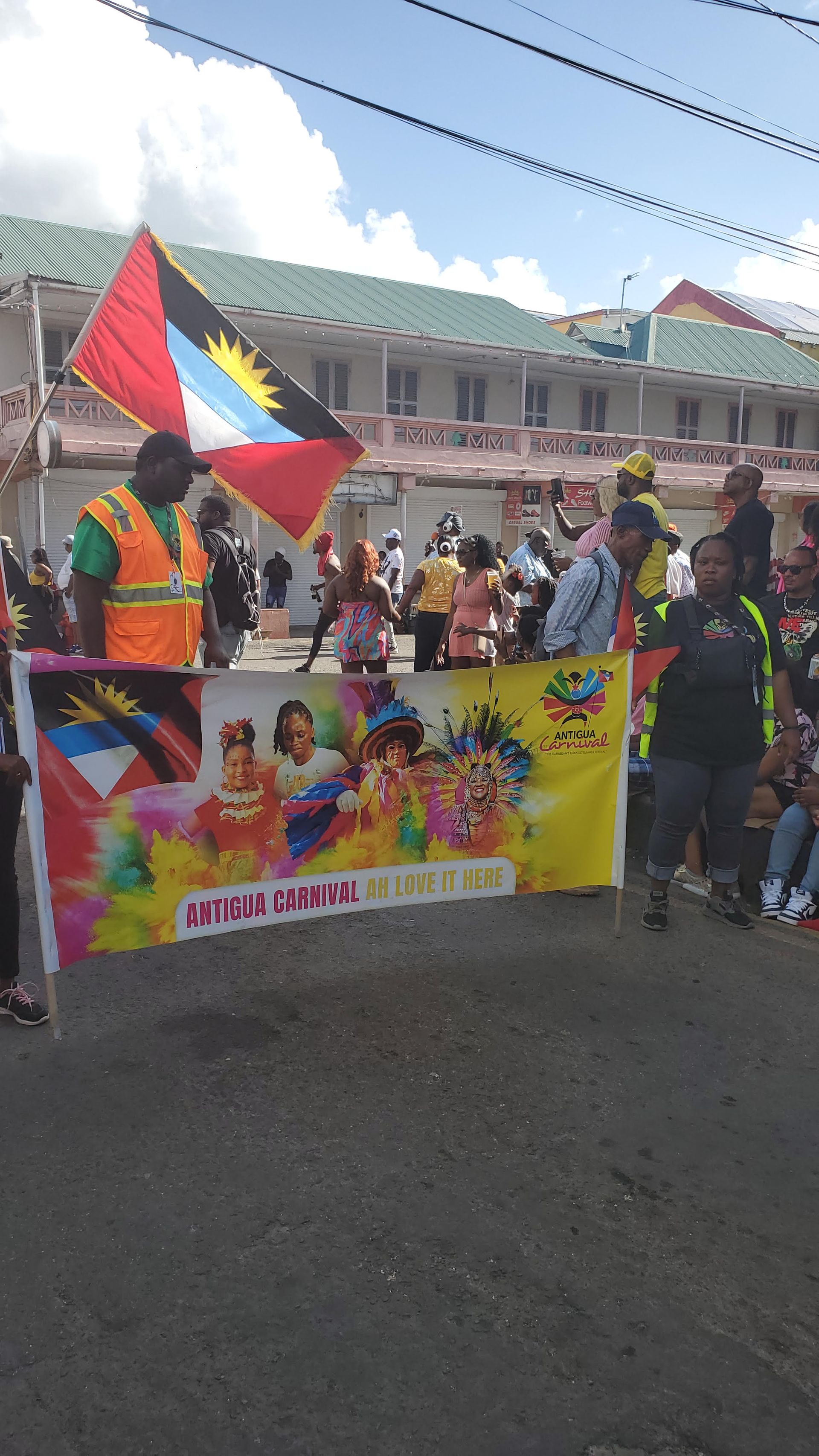 A group of people are holding flags and banners in a parade.