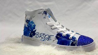 White high-top sneaker with blue floral designs and 