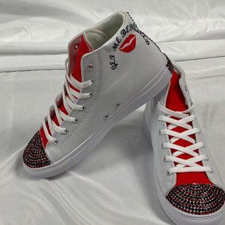 White high-top sneakers with red accents, jeweled toe caps, and 