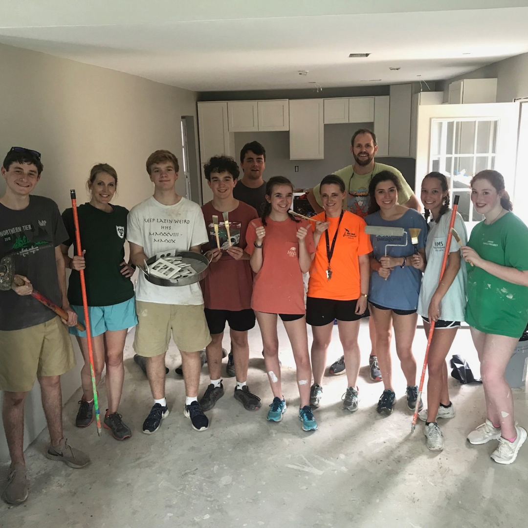 A group of people are posing for a picture in a room