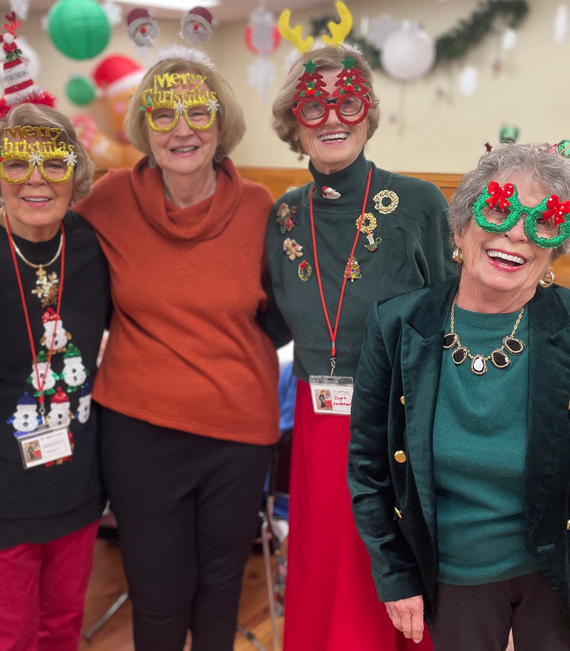 A group of women are posing for a picture wearing christmas glasses