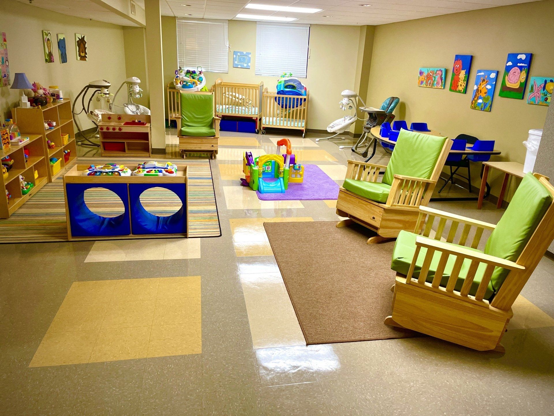 A room with a lot of toys and rocking chairs
