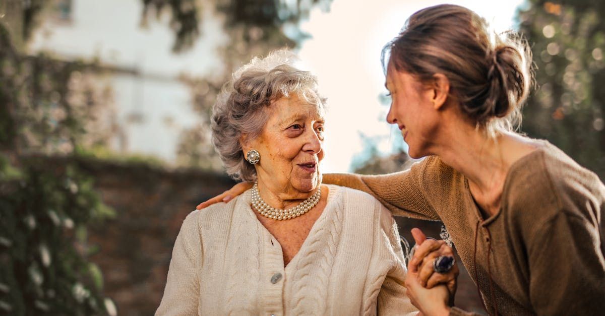 An elderly woman is talking to a younger woman.