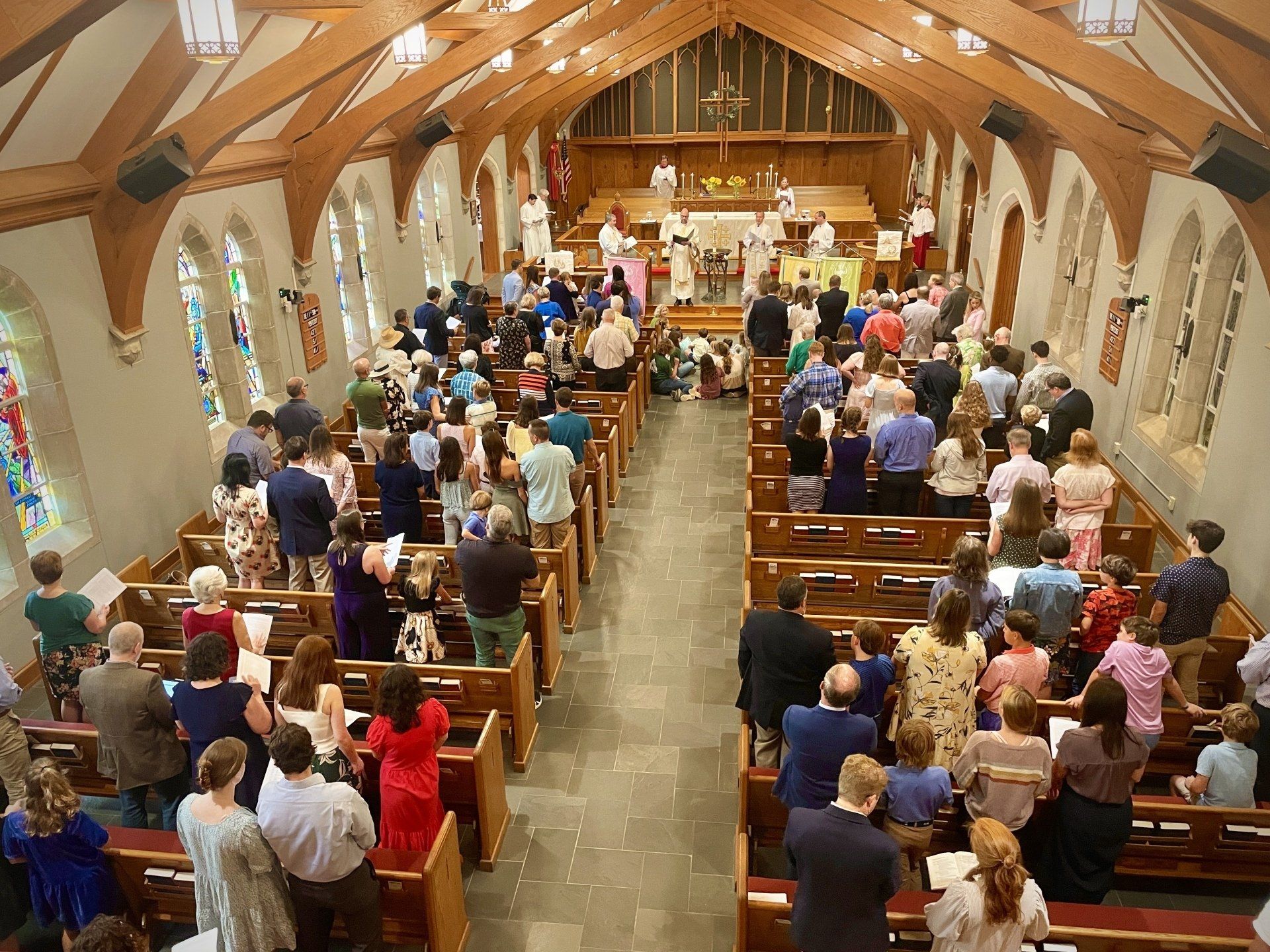 A large group of people are sitting in a church.