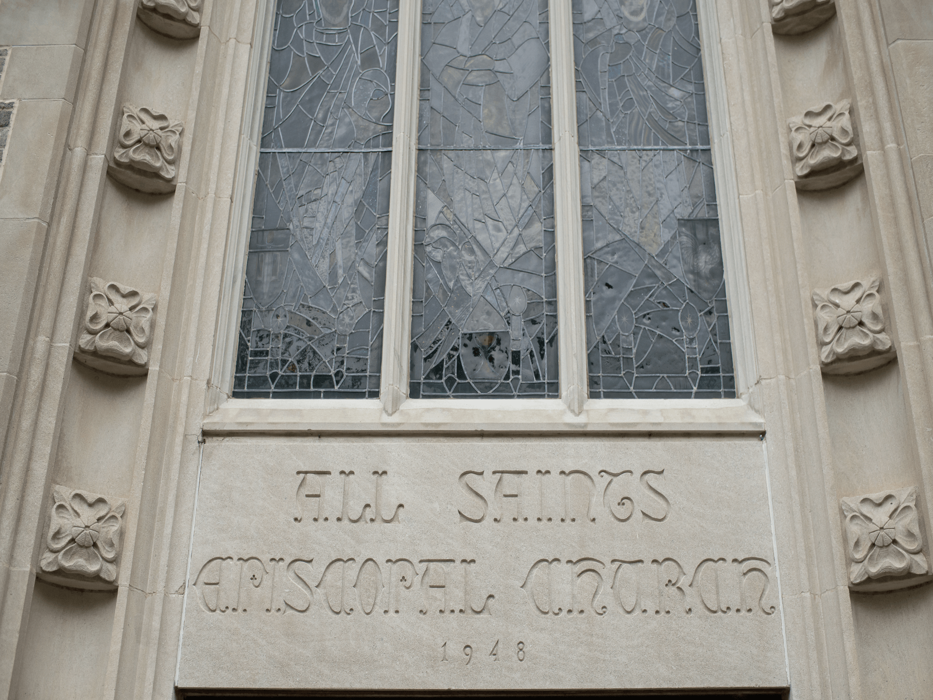 A building with a stained glass window that says fill shings episcopal church
