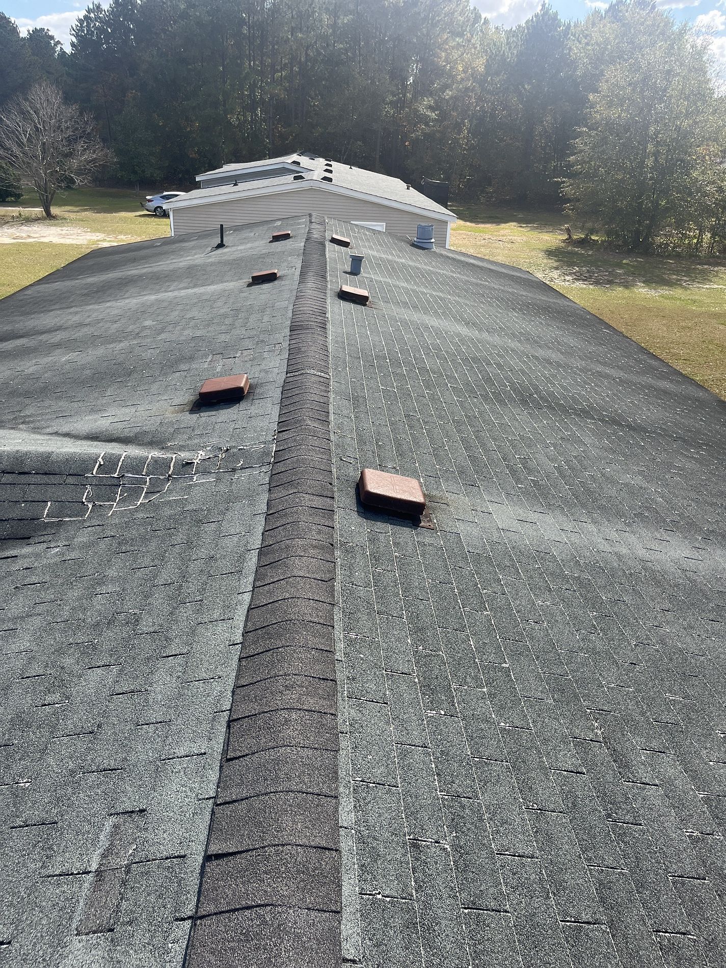 A roof with a lot of shingles on it and a lot of bricks on it.