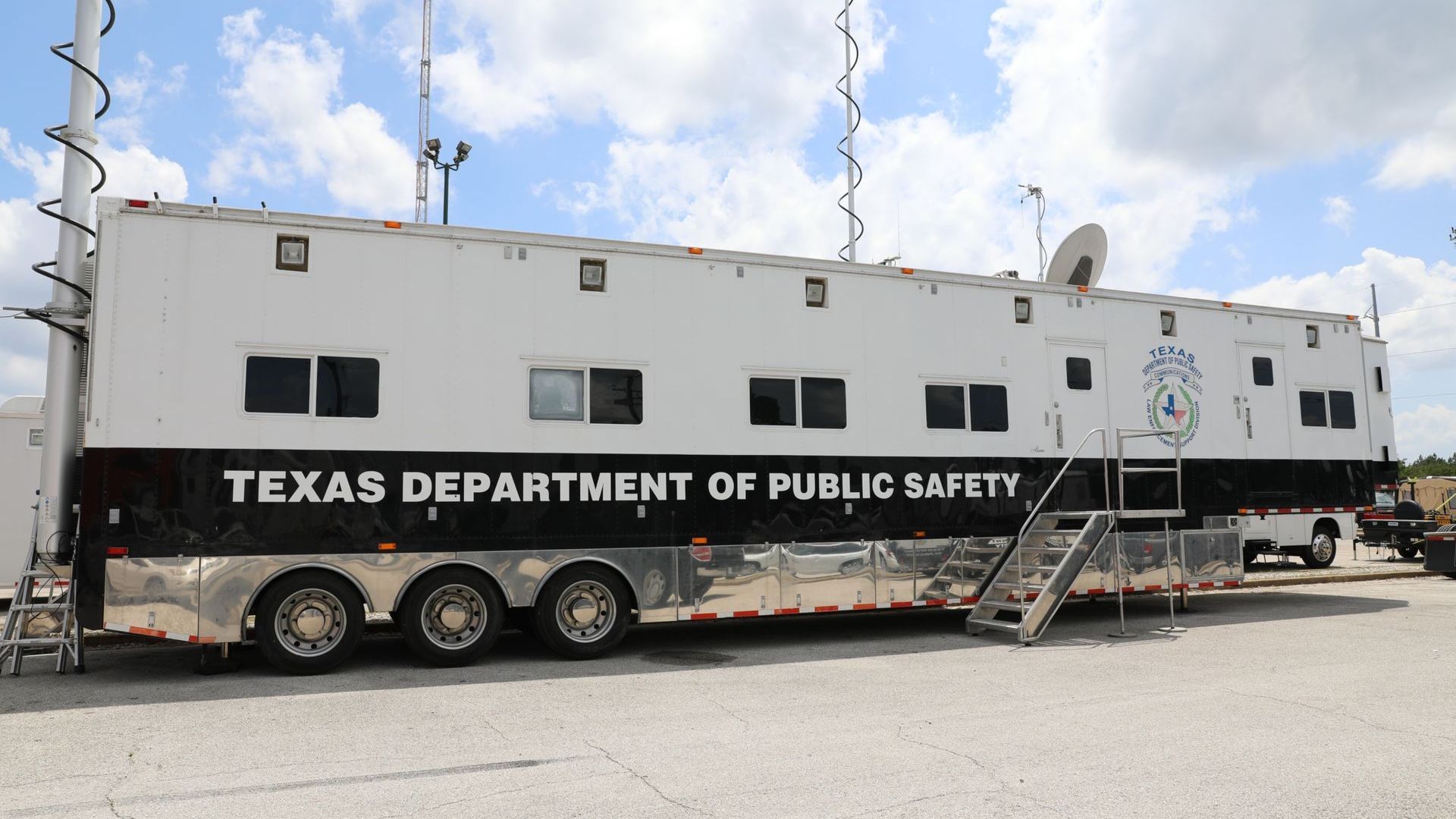 Texas Department of Public Safety mobile command center trailer with antennas, satellite dish, and stairs.