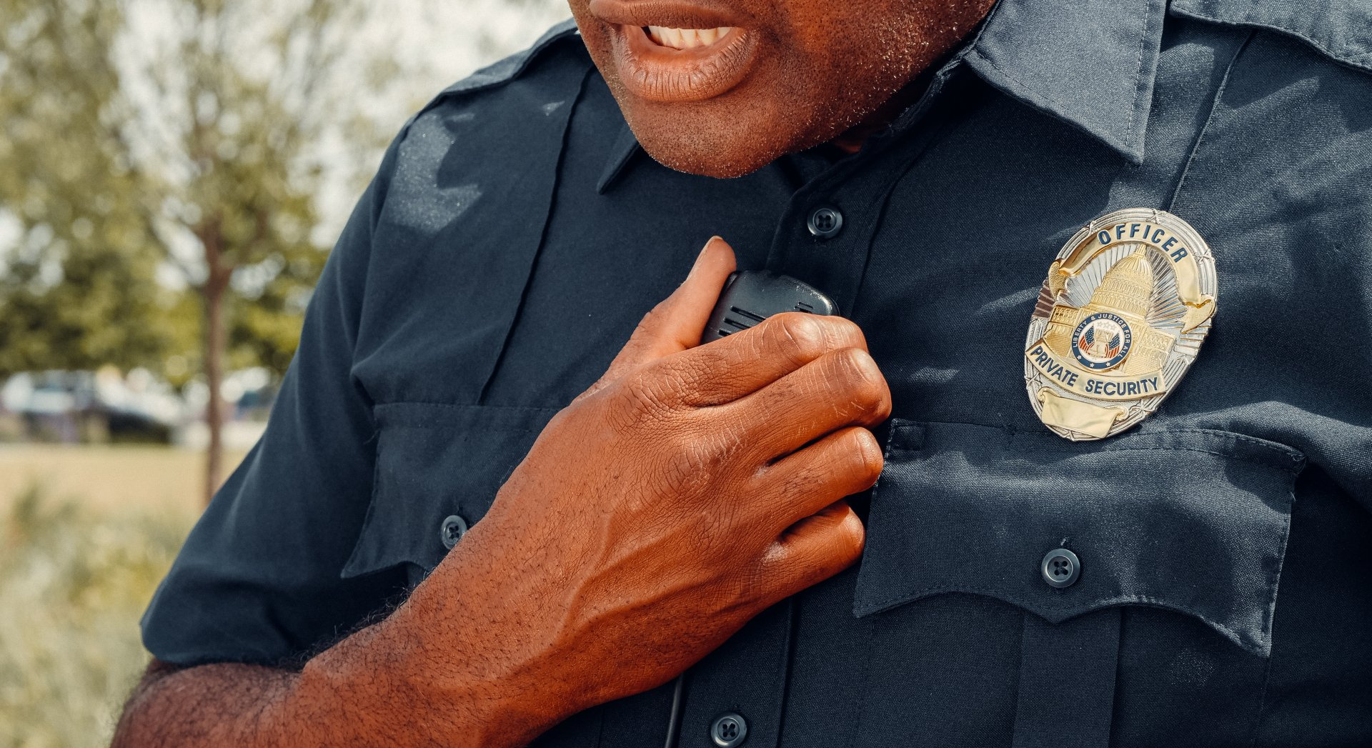 A police officer is talking on a walkie talkie.