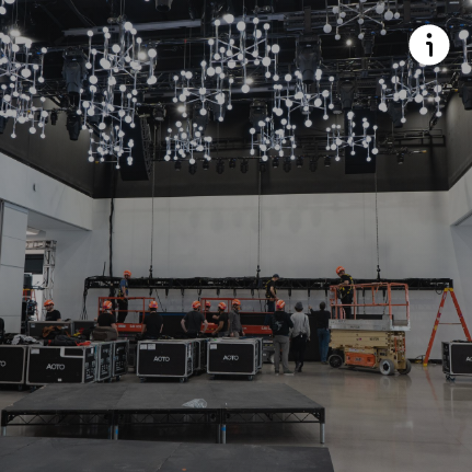 A large room with a lot of lights hanging from the ceiling