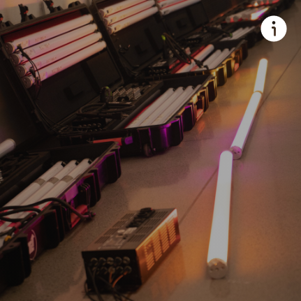 A bunch of lights are lined up on the floor