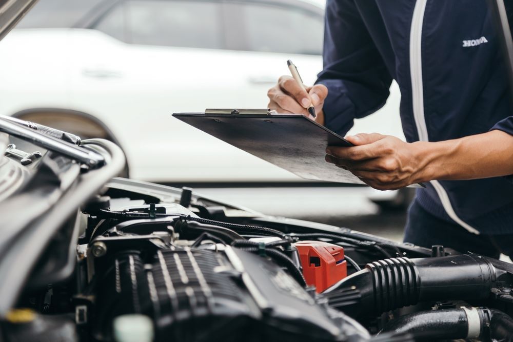 A Mechanic is Inspecting the Car — P & R Automotive Services in Pialba, QLD