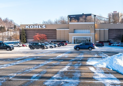 Snow-covered Kohl’s parking lot showing need for reliable commercial snow and ice management.