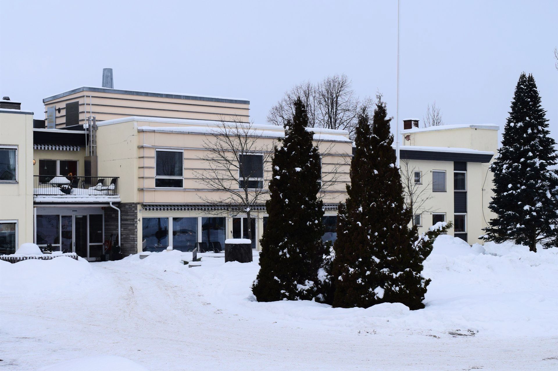 Snow-covered assisted living facility highlighting need for dependable winter property maintenance.