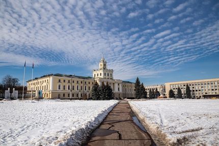 Snow-covered municipal building with cleared walkways, showing winter maintenance needs.