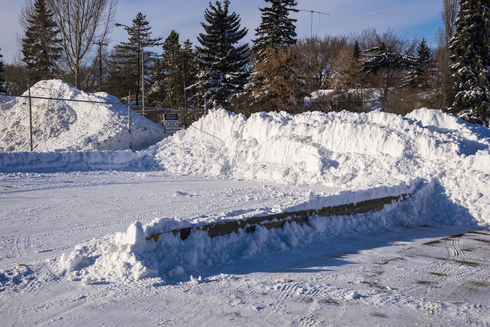 A large pile of snow is sitting in the middle of a snowy field