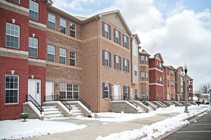 Snow along sidewalks at a managed residential complex highlighting winter maintenance needs.