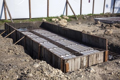 Foundation underpinning depicted in the picture with concrete poured between the iron beams