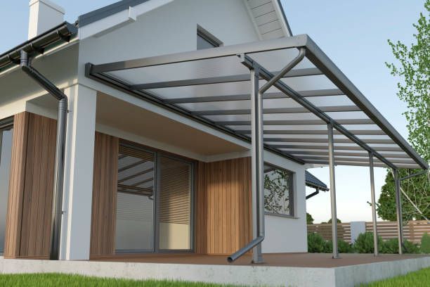 Modern house with a metal awning over the patio and large windows