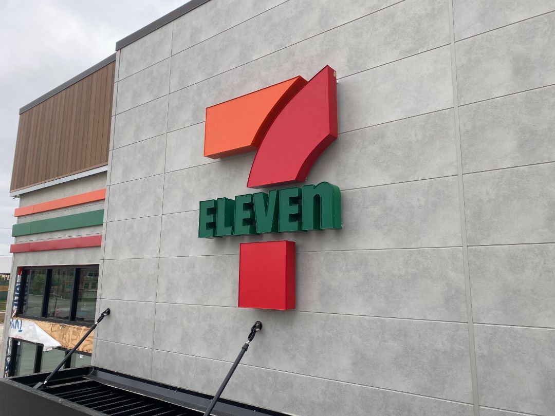 A 7 eleven store with a red and green logo