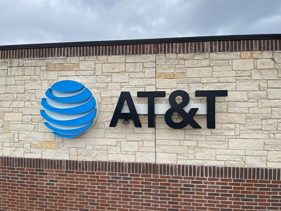 A sign for at & t on a brick wall