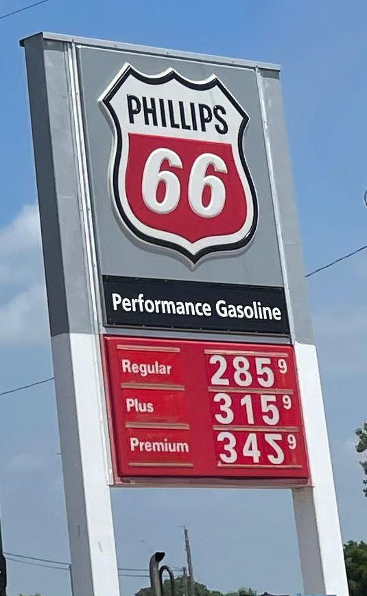 A phillips 66 gas station has a sign that says performance gasoline