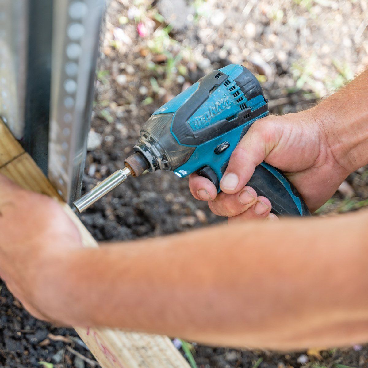 A person is holding a makita screwdriver in their hand.