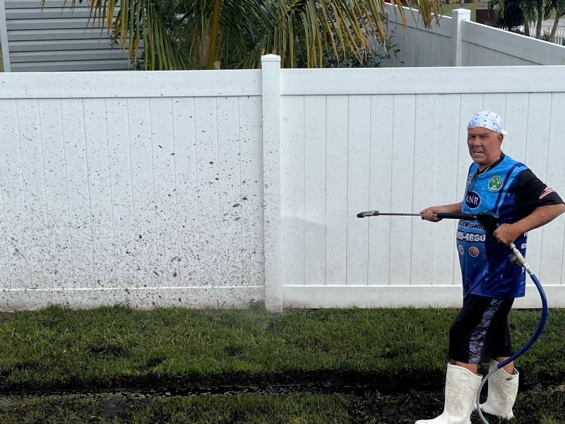Image of a fence cleaning in progress.