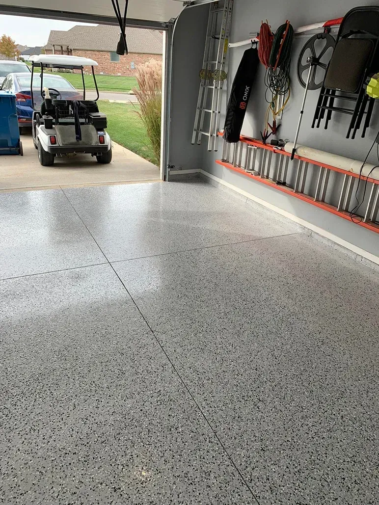 Garage interior with a golf cart near the open door and tools hanging on the wall