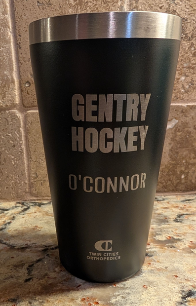 Black metal tumbler that has been laser etched.