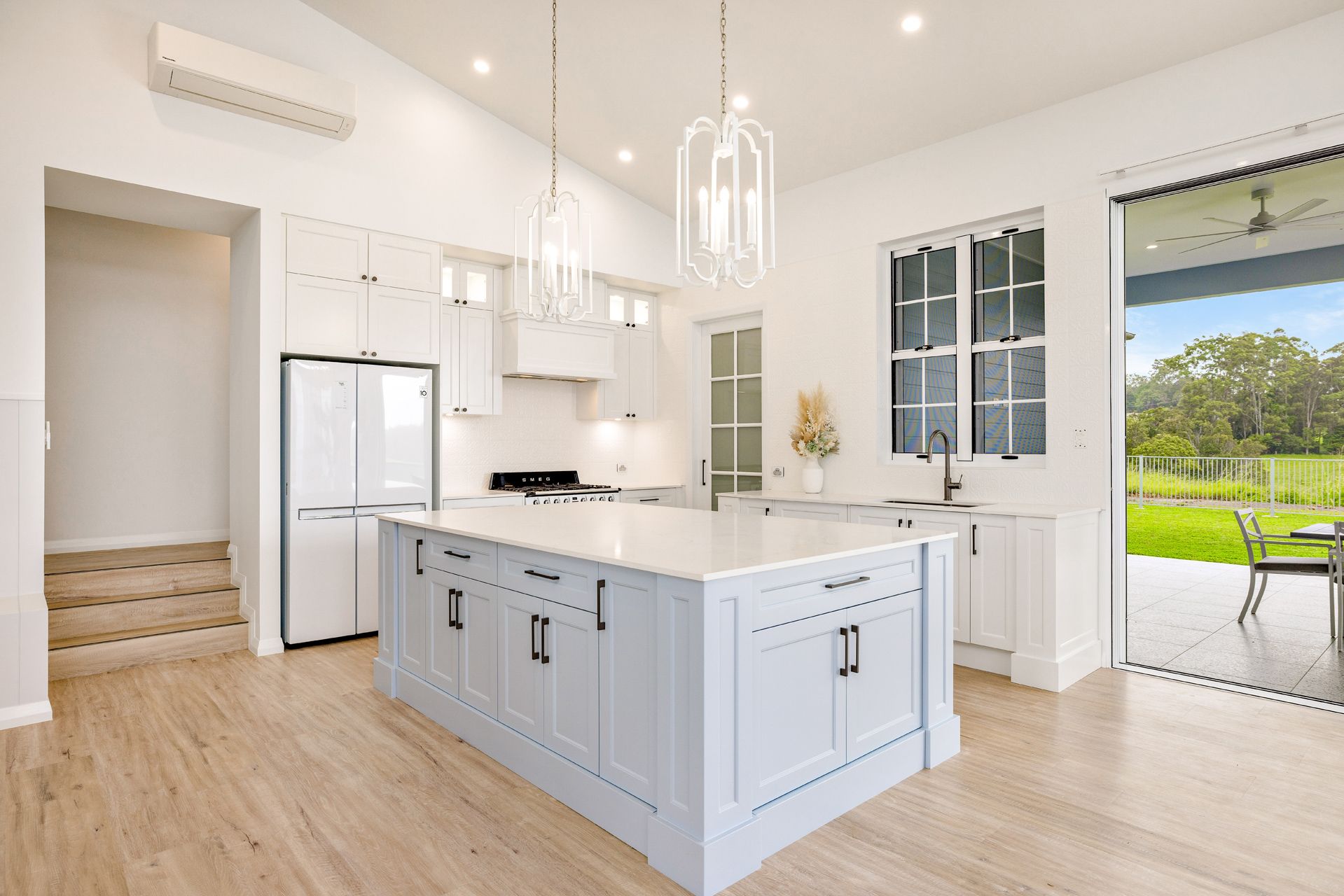 Modern White Kitchen With a Large Light Blue Island — Ashlee Jones Homes in Gordonvale, QLD