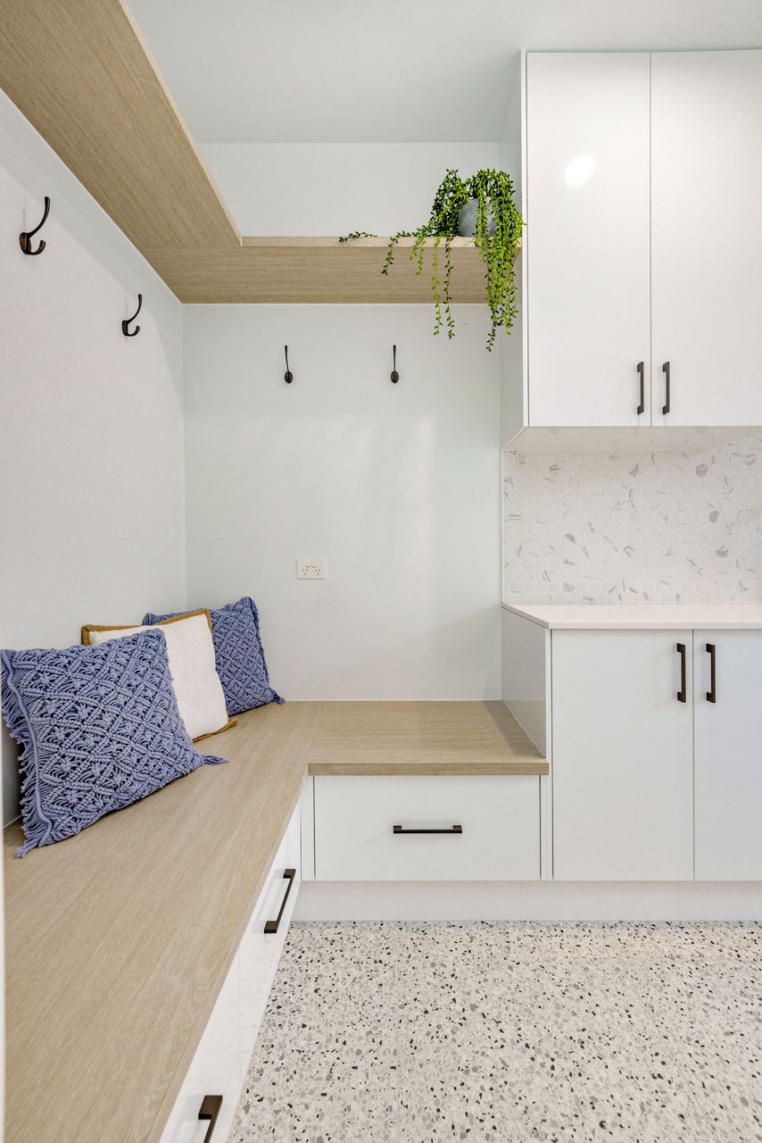 A Modern Mudroom With White Cabinets — Ashlee Jones Homes in Gordonvale, QLD