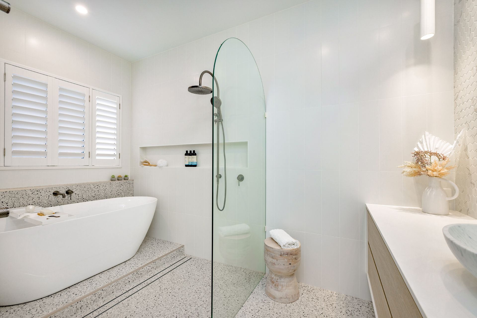 A Modern Bathroom Featuring a White Freestanding Tub — Ashlee Jones Homes in Gordonvale, QLD