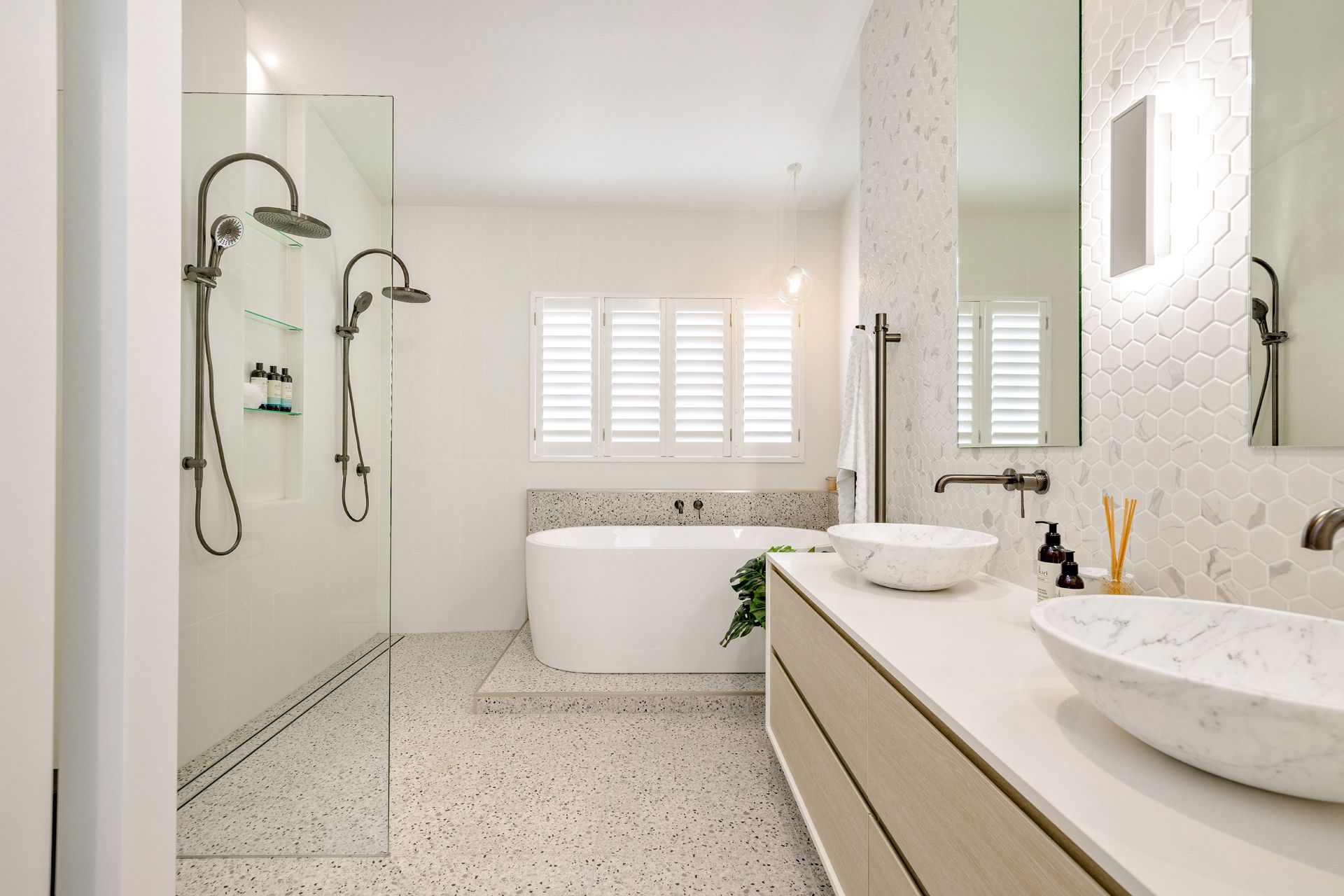 Modern, Bright White Bathroom With Terrazzo Floors, a Double Vanity — Ashlee Jones Homes in Gordonvale, QLD