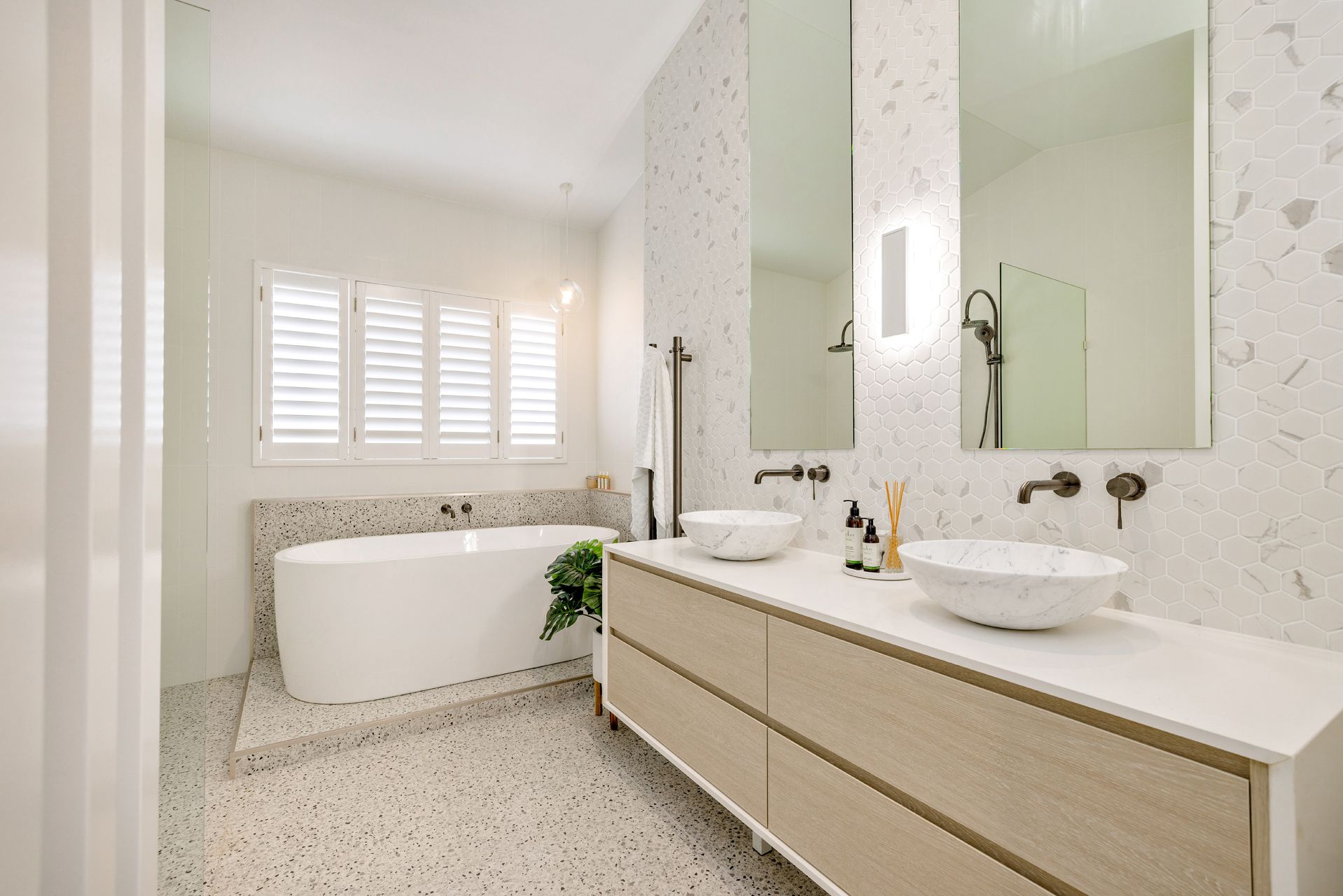 A Modern Bathroom Featuring a White Freestanding Tub — Ashlee Jones Homes in Gordonvale, QLD
