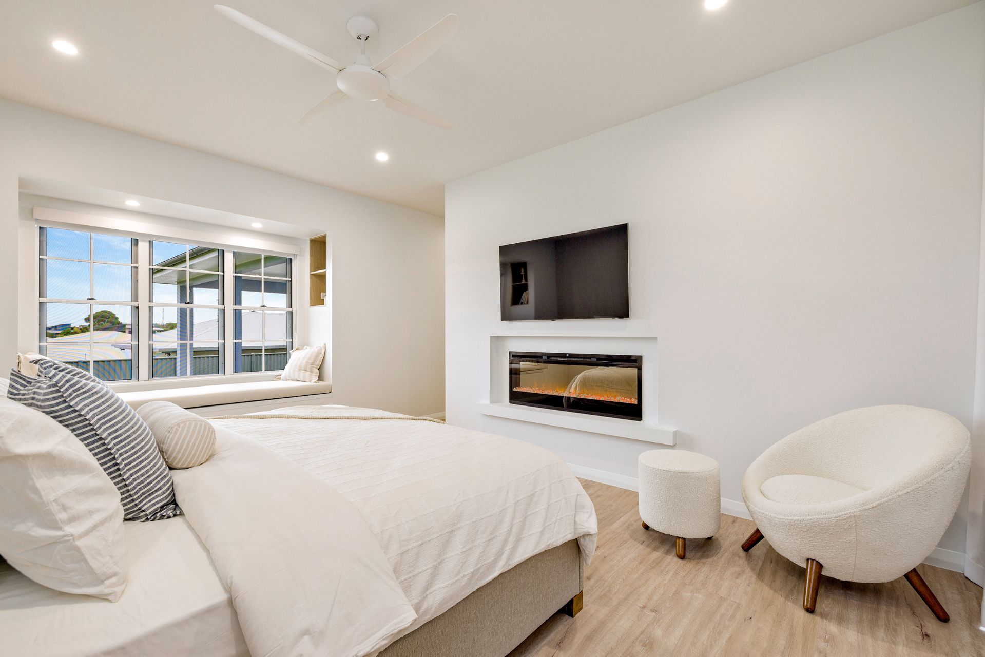 A Modern Bedroom With a Bed, Fireplace — Ashlee Jones Homes in Gordonvale, QLD