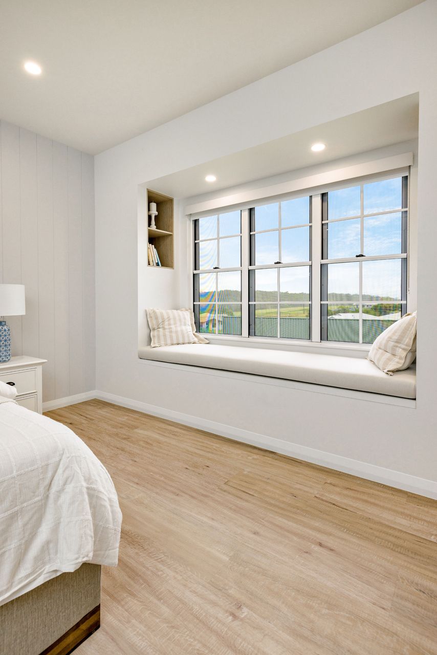 A Bright Bedroom Featuring a Built-in Window Seat — Ashlee Jones Homes in Gordonvale, QLD