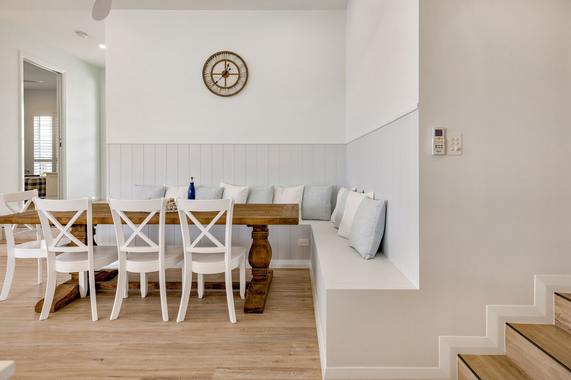 A Dining Area With a Rustic Wooden Table — Ashlee Jones Homes in Gordonvale, QLD